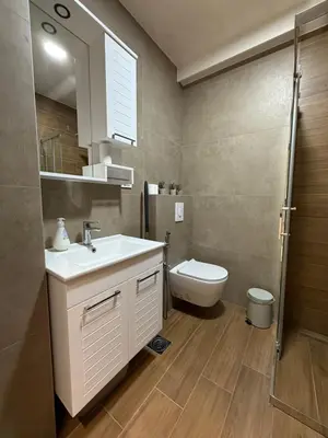 a bathroom with a sink and a toilet at Ornament Liman - Infinity Pool with Old Town View Apartments in Ulcinj