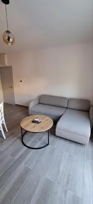 a living room with a couch and a coffee table at Apartmani Aki 1 in Sutomore
