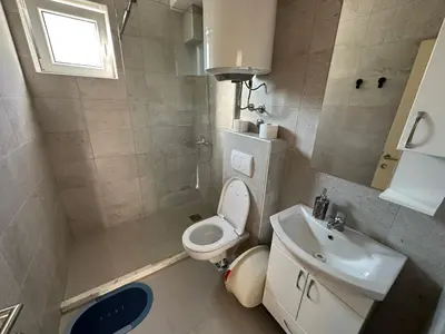 a small bathroom with a toilet and a sink at Apartmani Aki 1 in Sutomore