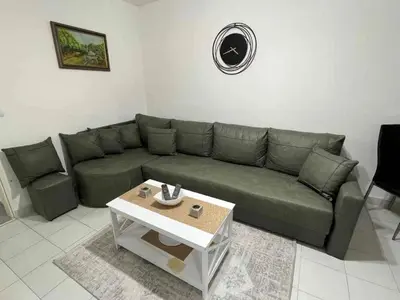 a living room with a green couch and a coffee table at Sivas Bar in Bar