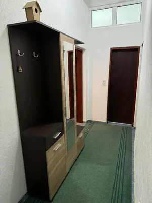 a room with a flat screen tv and a door at Apartman Pod lozom in Sutomore