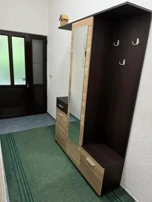 a wooden dresser with a mirror in a room at Apartman Pod lozom in Sutomore