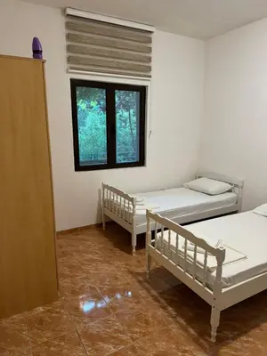 a room with two beds and a window at Apartman Pod lozom in Sutomore