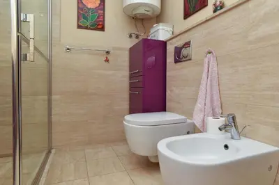 a bathroom with a toilet and a sink at Central lux apt with garage in Budva