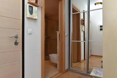 a bathroom with a glass door leading to a toilet at Central lux apt with garage in Budva