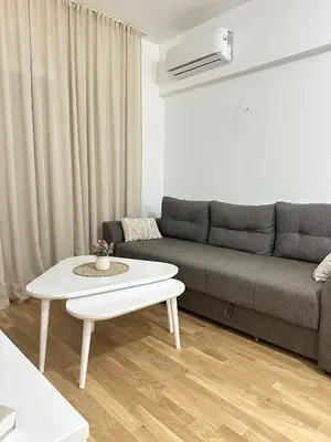 a living room with a couch and a coffee table at Aurora Mare in Bar