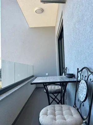 a table and chairs in a room with a window at Aurora Mare in Bar