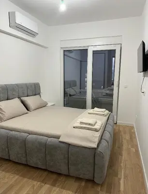 a bedroom with a bed and a large window at Aurora Mare in Bar
