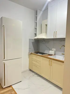 a kitchen with white appliances and a white refrigerator at Aurora Mare in Bar