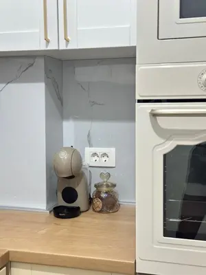 a kitchen with white cabinets and a counter top with a stove at Aurora Mare in Bar