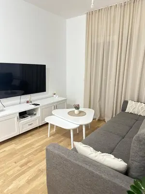 a living room with a couch and a tv at Aurora Mare in Bar