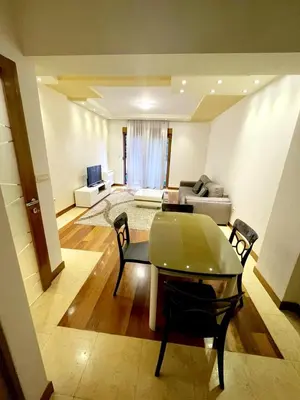 a living room with a table and a couch at CENTRAL apartment in Podgorica