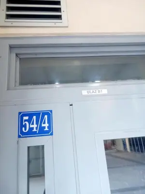 a door to a building with a sign on it at CENTRAL apartment in Podgorica