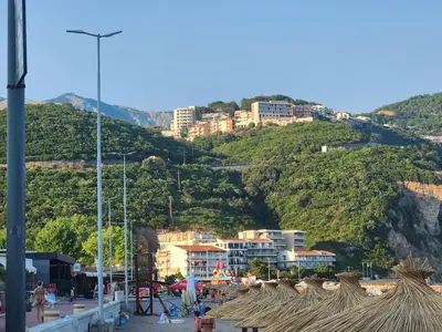 a group of buildings on a hill with a city at Sunny Apartment in Prijevor