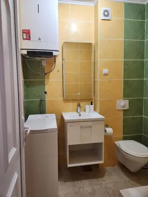 a small bathroom with a sink and a toilet at Sunny Apartment in Prijevor