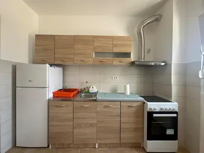 a kitchen with a white refrigerator and a sink at Modern 2BR - Smart TV and WiFi in Podgorica