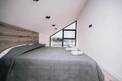 a bedroom with a large bed and a large window at Casa Rio in Ulcinj
