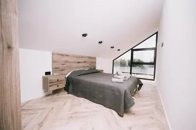 a bedroom with a large bed and a large window at Casa Rio in Ulcinj