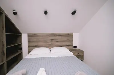 a bedroom with a bed with two white pillows at Casa Rio in Ulcinj