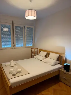 a bedroom with a bed with two towels on it at Top-Top 2 in Podgorica