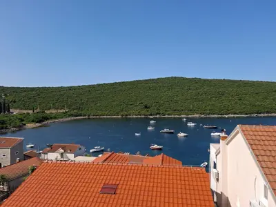 a view of a harbor with boats in the water at Apartment Bigovo in Tivat
