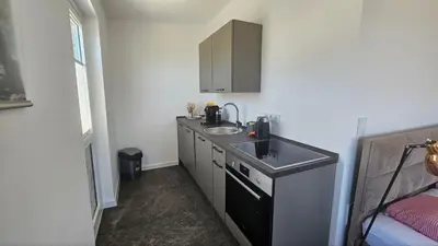 a small kitchen with a sink and a counter at Panorama Suite in Dobra Voda