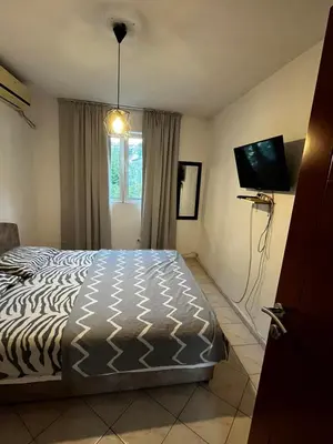 a bedroom with a bed and a flat screen tv at Krsto in Budva