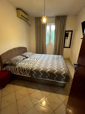 a bed sitting in a room with a window at Krsto in Budva