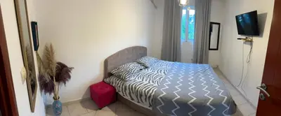 a bedroom with a bed and a television in it at Krsto in Budva
