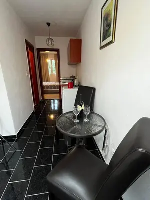 a kitchen with a table and two glasses of wine at Krsto in Budva