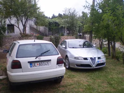 two cars parked next to each other in a yard at Apartment Vuk i Novak in Ulcinj