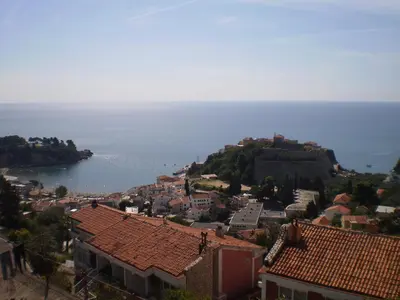a town on a hill with the ocean in the background at Apartment Vuk i Novak in Ulcinj