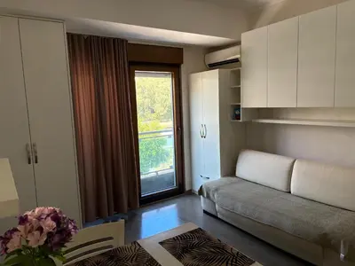 a living room with a couch and a window at Njaro Del Mar Studio 13 in Petrovac na Moru