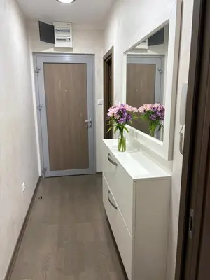 a bathroom with a sink and a mirror and flowers at Njaro Del Mar Studio 13 in Petrovac na Moru