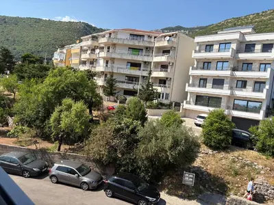 a group of cars parked in a parking lot in front of a building at Njaro Del Mar Studio 13 in Petrovac na Moru