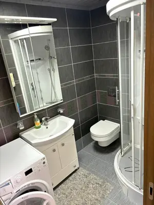 a bathroom with a sink and a washing machine at Njaro Del Mar Studio 13 in Petrovac na Moru