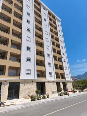 a tall white building with a street in front of it at Sea & Sand Apartment in Bar