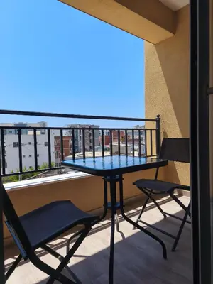 a table and chairs on a balcony with a view at Sea & Sand Apartment in Bar