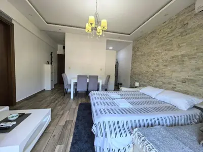 a bedroom with two beds and a brick wall at City View 7 - Budva Center in Budva