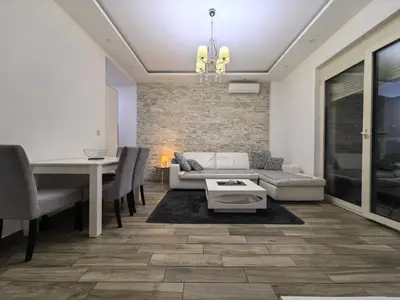 a living room with a couch and a table at City View 7 - Budva Center in Budva