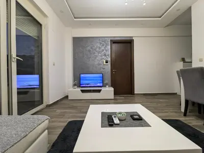 a living room with a couch and a tv at City View 7 - Budva Center in Budva