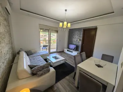 a living room with a couch and a table at City View 7 - Budva Center in Budva