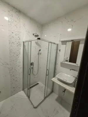 a bathroom with a glass shower and a sink at City View 7 - Budva Center in Budva