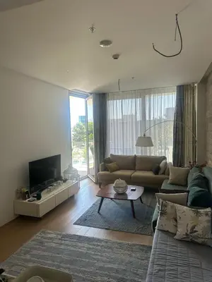 a living room with a couch and a tv at Dukley Residence Budva Old Town in Budva