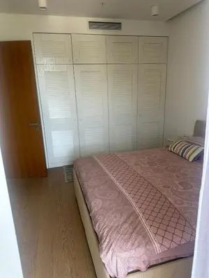 a bedroom with a bed with a pink blanket at Dukley Residence Budva Old Town in Budva