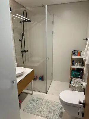 a bathroom with a shower and a toilet and a sink at Dukley Residence Budva Old Town in Budva