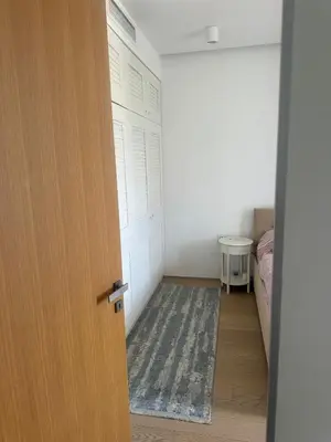 a door leading to a bedroom with a bed and a rug at Dukley Residence Budva Old Town in Budva