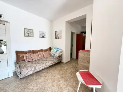 a living room with a couch and a chair at Sutomore Two Bedroom Apartment in Sutomore