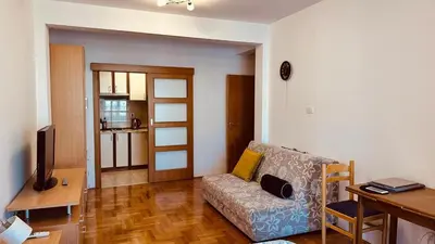 a living room with a couch and a table at Budva Summer House in Budva