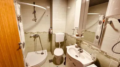 a small bathroom with a toilet and a sink at Budva Summer House in Budva